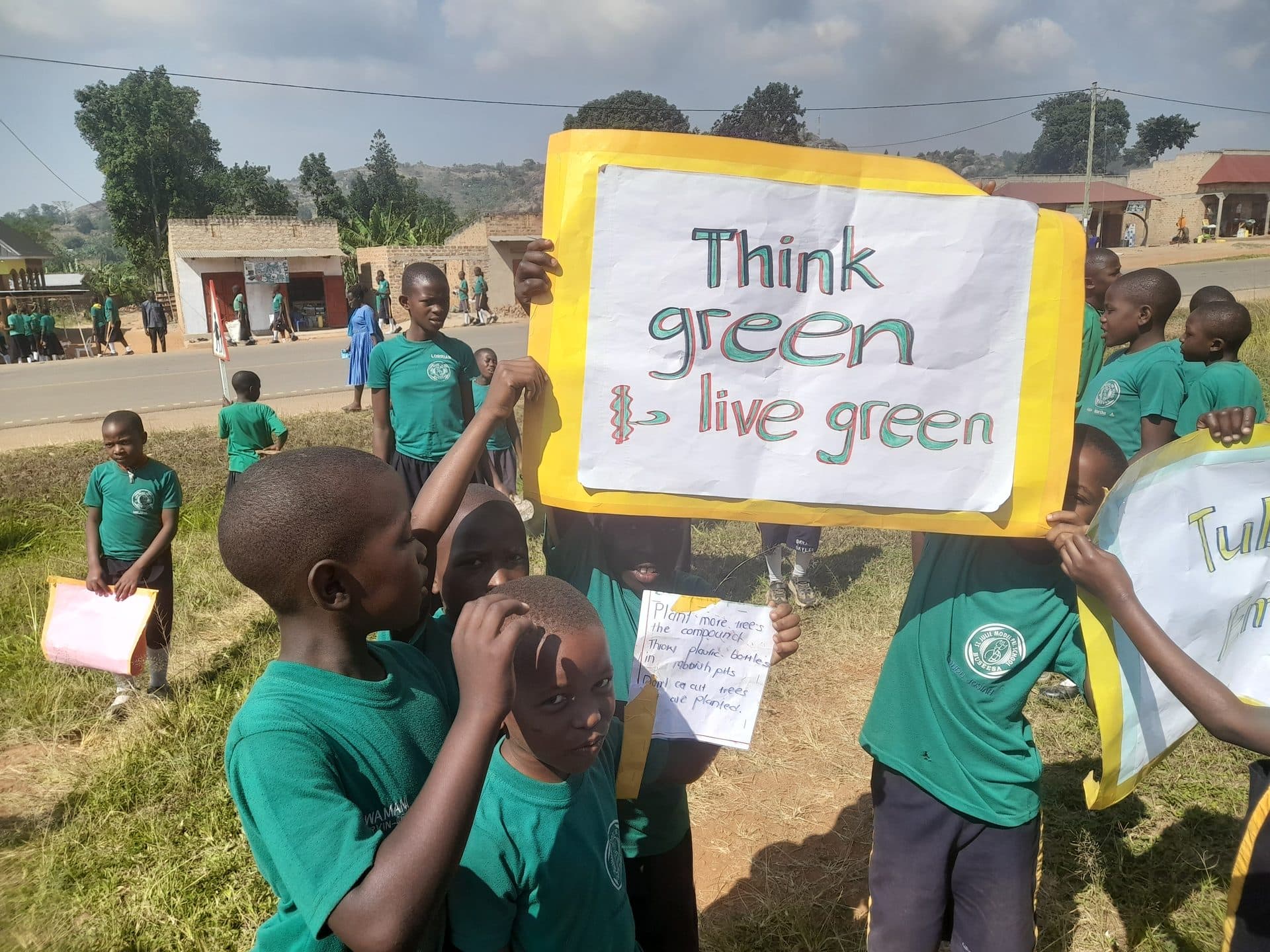 Learners marching with a 'Think Green, Live Green' banner