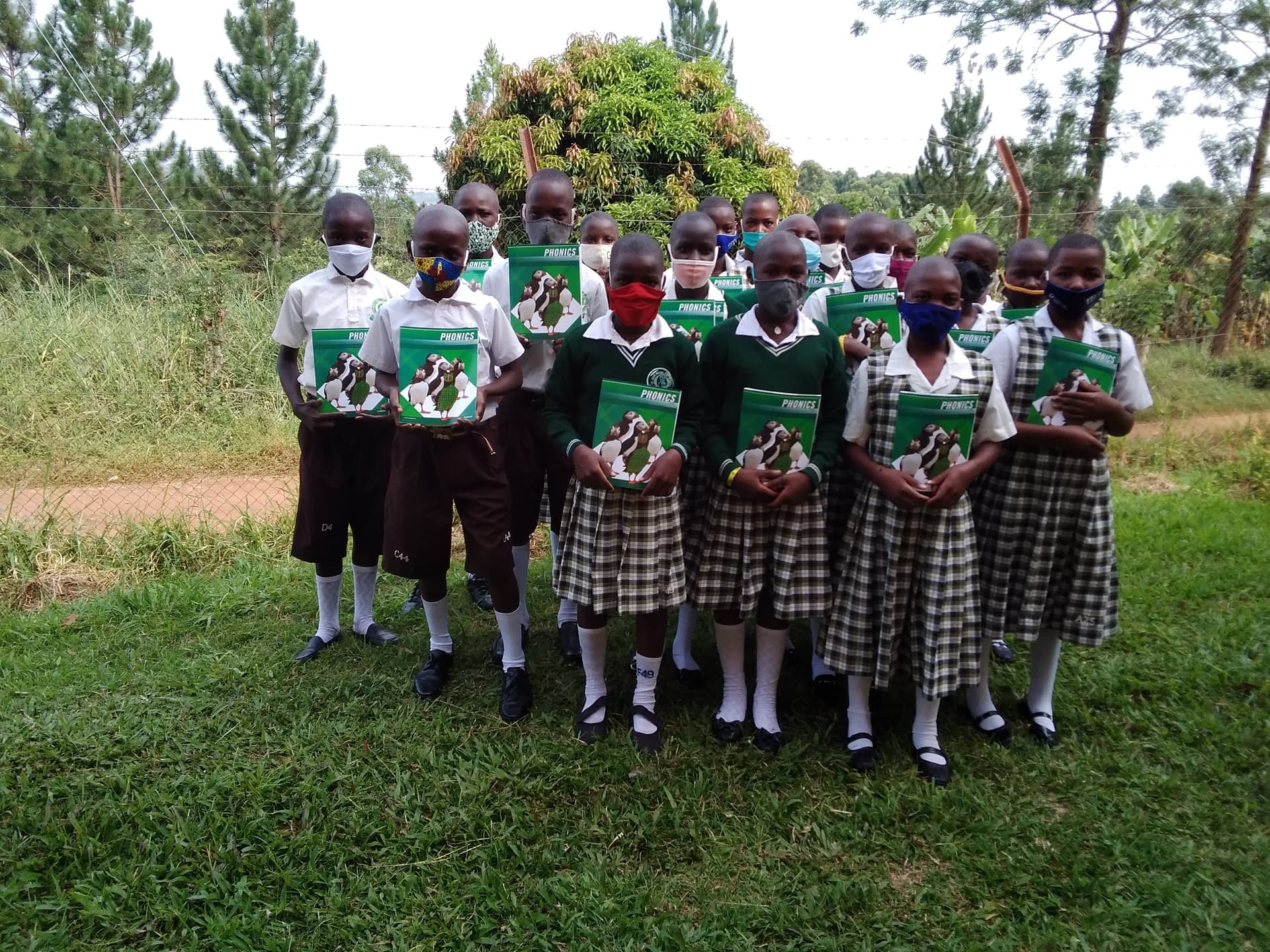 Boarding pupils at St. Julie Model holding their phonics books