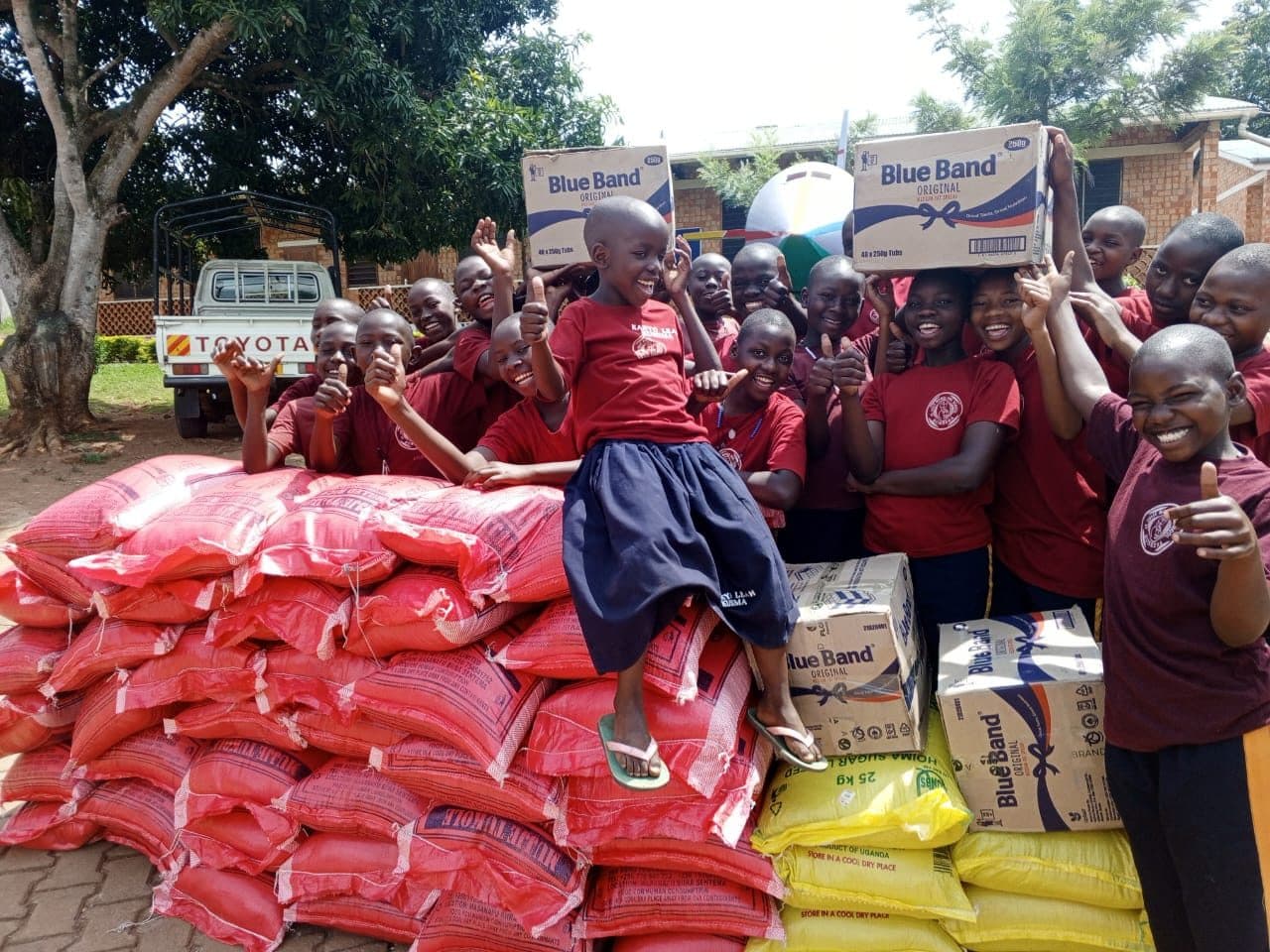 Learners celebrating with donated food supplies